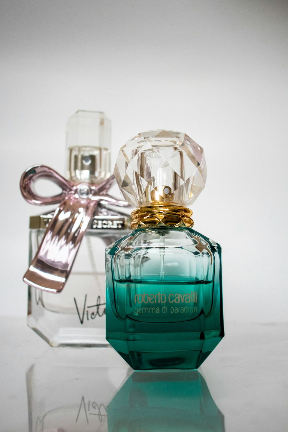 two clear glass labeled spray bottles